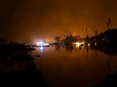 Flames are seen near Lahaina as wildfires driven by high winds destroy a large part of the historic town of Lahaina, in Kahului, Hawaii, U.S. August 9, 2023. Dustin Johnson/Handout via REUTERS THIS IMAGE HAS BEEN SUPPLIED BY A THIRD PARTY.