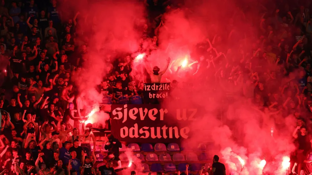 Soccer Football - Champions League - Qualifying Third Round - First Leg - Dinamo Zagreb v AEK Athens - Maksimir stadium, Zagreb, Croatia - August 15, 2023 Dinamo Zagreb fans with flares and a banner reading "hold on brothers" in the stands REUTERS/Antonio Bronic