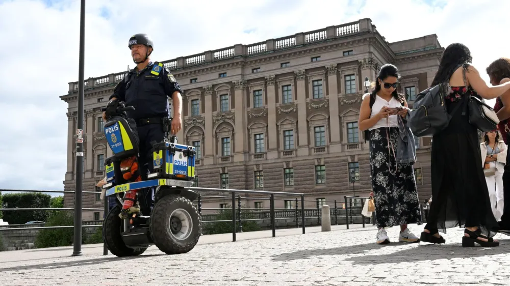 A police officer on a Segway patrols Sweden's parliament Riksdagen as the terror threat level in Sweden is raised to four on a five-point scale, in Stockholm, Sweden, August 17, 2023. Fredrik Sandberg/TT News Agency/via REUTERS   ATTENTION EDITORS - THIS IMAGE WAS PROVIDED BY A THIRD PARTY. SWEDEN OUT. NO COMMERCIAL OR EDITORIAL SALES IN SWEDEN.