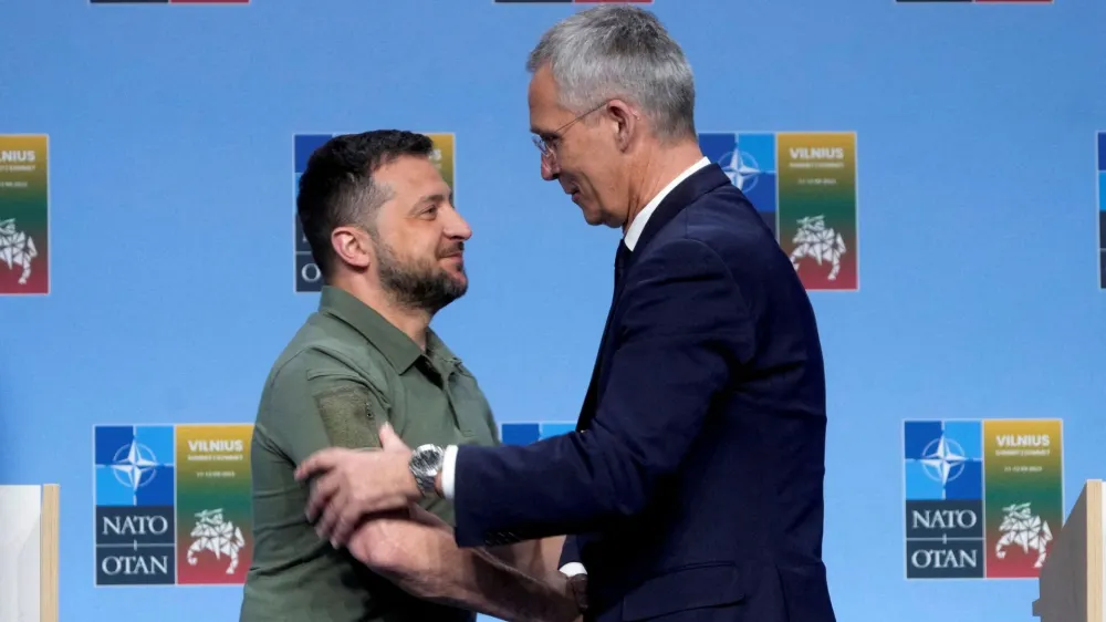 FILE PHOTO: Ukraine's President Volodymyr Zelenskiy and NATO Secretary-General Jens Stoltenberg shake hands at a press conference during a NATO leaders summit in Vilnius, Lithuania, July 12, 2023. REUTERS/Ints Kalnins/File Photo