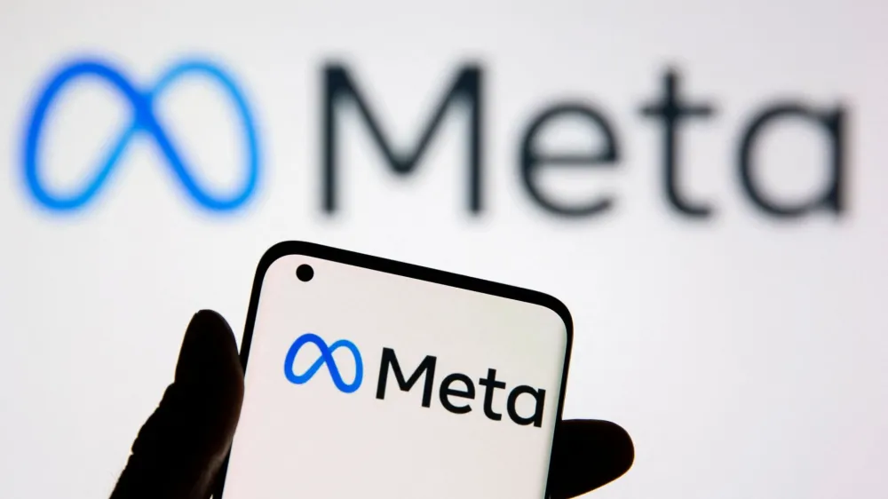 FILE PHOTO: A smartphone with Meta logo is seen in front of displayed Facebook's new rebrand logo Meta in this illustration taken, October 28, 2021. REUTERS/Dado Ruvic/Illustration/File Photo