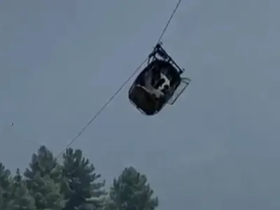 In this image taken from video, a cable car carrying six children and two adults dangles hundreds of meters above the ground in the remote Battagram district, Khyber Pakhtunkhwa, Pakistan on Tuesday, Aug. 22, 2023. The cable car malfunctioned, trapping the occupants for hours before rescuers arrived in helicopters to try to free them. (AP Photo)