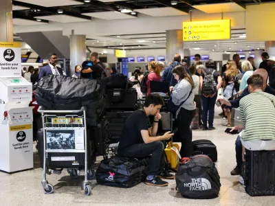 Travellers wait near the British Airways check-in area at Heathrow Airport, as Britain's National Air Traffic Service (NATS) restricts UK air traffic due to a technical issue causing delays, in London, Britain, August 28, 2023. REUTERS/Hollie Adams