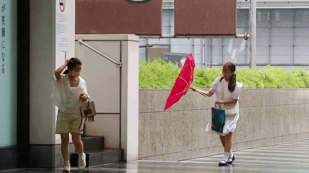 People walk on a street as Typhoon Haikui approaches, in Taipei, Taiwan September 3, 2023. REUTERS/Ann Wang