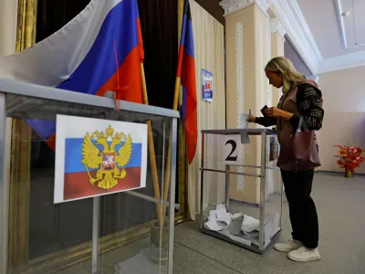 A voter casts her ballot at a polling station during local elections held by the Russian-installed authorities in the course of Russia-Ukraine conflict in the settlement of Panteleimonivka in the Donetsk region, Russian-controlled Ukraine, September 10, 2023. REUTERS/Alexander Ermochenko