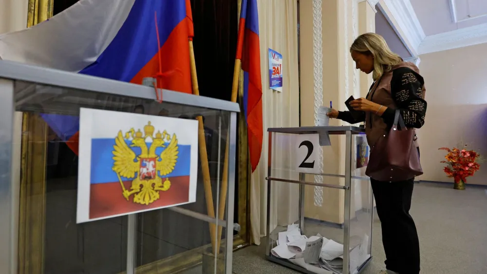 A voter casts her ballot at a polling station during local elections held by the Russian-installed authorities in the course of Russia-Ukraine conflict in the settlement of Panteleimonivka in the Donetsk region, Russian-controlled Ukraine, September 10, 2023. REUTERS/Alexander Ermochenko