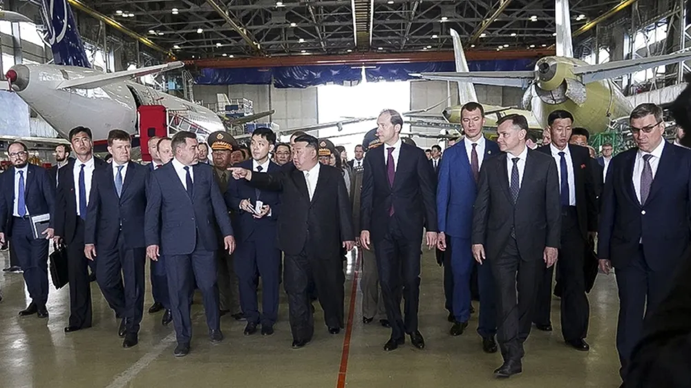 In this photo released by the governor of the Russian far eastern region of Khabarovsky Krai region Mikhail Degtyarev telegram channel, North Korean leader Kim Jong Un, center, and Deputy Prime Minister and Minister of Trade and Industry Denis Manturov, center right, visit a Russian aircraft plant that builds fighter jets in Komsomolsk-on-Amur, about 6,200 kilometers (3,900 miles) east of Moscow, Russia. (The governor of the Russian far eastern region of Khabarovsky Krai region Mikhail Degtyarev telegram channel via AP)