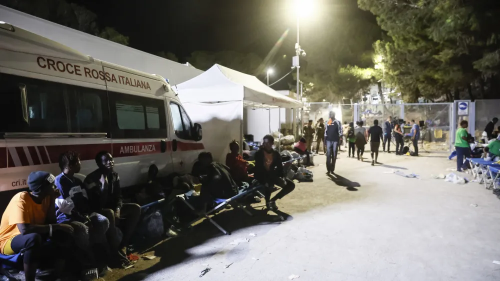 15 September 2023, Italy, Lampedusa: Migrants gather near an operational centre called "Hotspot" on the Italian island of Lampedusa. More than 8,000 boat migrants have landed on Lampedusa since the beginning of the week, leading to chaotic scenes in the Italian island's overcrowded reception centre. Photo: Cecilia Fabiano/LaPresse via ZUMA Press/dpa