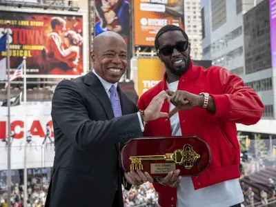 This photo provided by the Office of the New York Mayor, shows Mayor Eric Adams, left, presenting the Key to the City to hip-hop artist Sean "Diddy" Combs in New York's Times Square, Friday, Sept. 15, 2023. (Office of the New York Mayor/Caroline Rubinstein-Willis via AP)