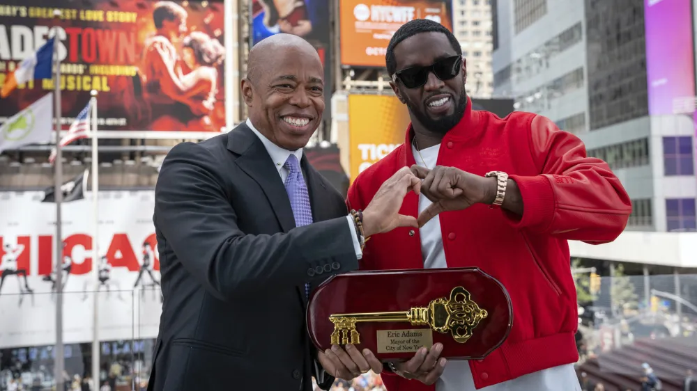 This photo provided by the Office of the New York Mayor, shows Mayor Eric Adams, left, presenting the Key to the City to hip-hop artist Sean "Diddy" Combs in New York's Times Square, Friday, Sept. 15, 2023. (Office of the New York Mayor/Caroline Rubinstein-Willis via AP)