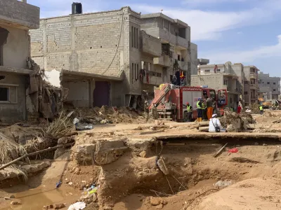 Rescue teams search for victims in Derna, Libya, on Sunday, Sept. 17, 2023. Libyan authorities have opened an investigation into the collapse of two dams that caused a devastating flood in a Derna as rescue teams searched for bodies on Saturday, nearly a week after the deluge killed more than 11,000 people. (AP Photo/Yousef Murad)