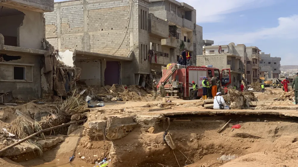 Rescue teams search for victims in Derna, Libya, on Sunday, Sept. 17, 2023. Libyan authorities have opened an investigation into the collapse of two dams that caused a devastating flood in a Derna as rescue teams searched for bodies on Saturday, nearly a week after the deluge killed more than 11,000 people. (AP Photo/Yousef Murad)