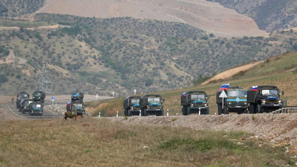 FILE PHOTO: Vehicles of Russian peacekeepers leaving Azerbaijan's Nagorno-Karabakh region for Armenia pass an Armenian checkpoint on a road near the village of Kornidzor, Armenia September 22, 2023. REUTERS/Irakli Gedenidze/File Photo