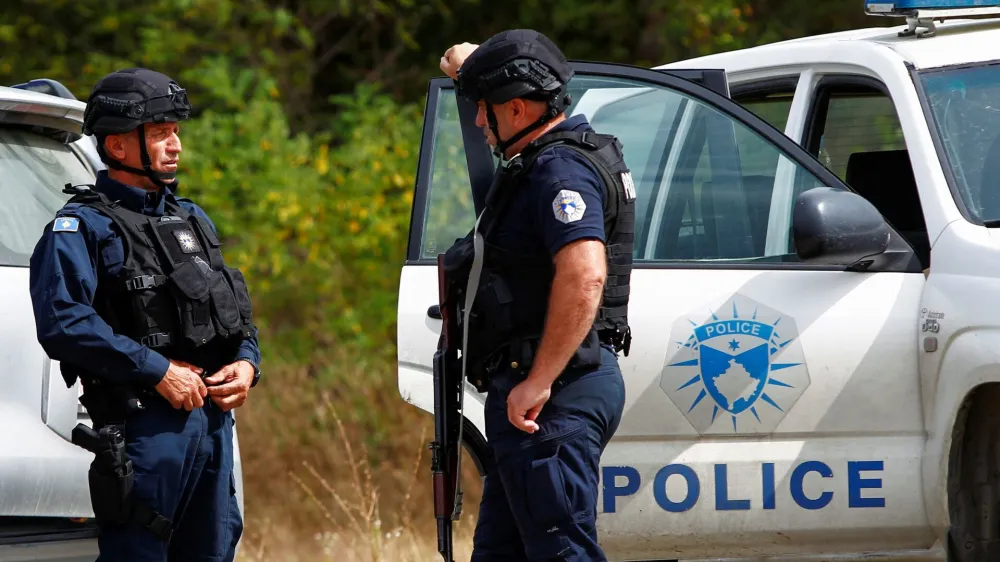 Police officers stand guard in the aftermath of a shooting, near the village of Zvecane, Kosovo September 24, 2023. REUTERS/Ognen Teofilovski