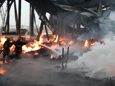 Specialists work to extinguish fire following an explosion at a warehouse near an airport in Tashkent, Uzbekistan, in this picture released September 28, 2023. Government of Uzbekistan/Handout via REUTERS ATTENTION EDITORS - THIS IMAGE WAS PROVIDED BY A THIRD PARTY. NO RESALES. NO ARCHIVES. MANDATORY CREDIT.