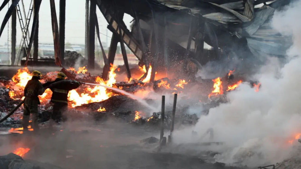 Specialists work to extinguish fire following an explosion at a warehouse near an airport in Tashkent, Uzbekistan, in this picture released September 28, 2023. Government of Uzbekistan/Handout via REUTERS ATTENTION EDITORS - THIS IMAGE WAS PROVIDED BY A THIRD PARTY. NO RESALES. NO ARCHIVES. MANDATORY CREDIT.