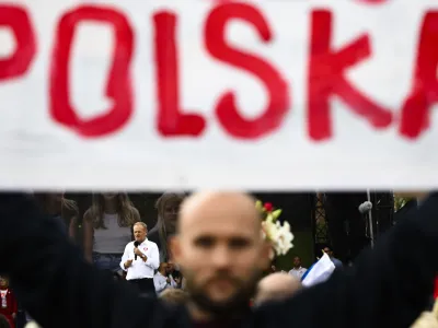 Opposition leader Donald Tusk speaks behind a poster Poland during a march to support the opposition against the governing populist Law and Justice party in Warsaw, Poland, Sunday, Oct. 1, 2023. Polish opposition leader Donald Tusk seeks to boost his election chances for the parliament elections on Oct. 15, 2023, leading the rally in the Polish capital. (AP Photo/Rafal Oleksiewicz)