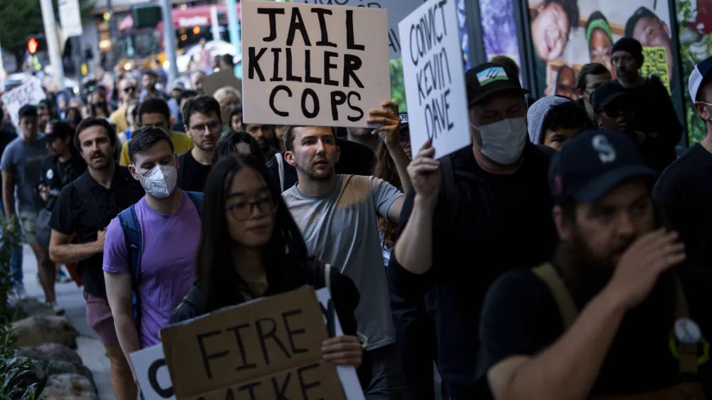 FILE - Protesters march through downtown Seattle after body camera footage was released of a Seattle police officer joking about the death of Jaahnavi Kandula, a 23-year-old woman hit and killed in January by officer Kevin Dave in a police cruiser, Sept. 14, 2023, in Seattle. A Seattle police officer and union leader under investigation for laughing and making callous remarks about the death of Kandula, from India, who was struck by a police SUV, has been taken off patrol duty, police said Thursday, Sept. 28. (AP Photo/Lindsey Wasson, File)