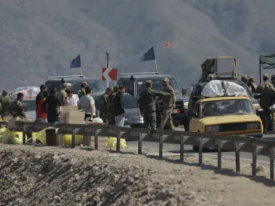 Ethnic Armenians from Nagorno-Karabakh and European Union observers drive their cars past a check point on the road from Nagorno-Karabakh to Armenia's Goris in Syunik region, Armenia, Friday, Sept. 29, 2023. Armenian officials say more than 70% of Nagorno-Karabakh's original population have fled the region for Armenia. (AP Photo/Vasily Krestyaninov)