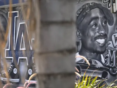 A portion of a mural by artist sloe_motions depicting Tupac Shakur is seen on the side of Speedy Auto Tint on Friday, Sept. 29, 2023, in Bellflower, Calif. (AP Photo/Chris Pizzello)