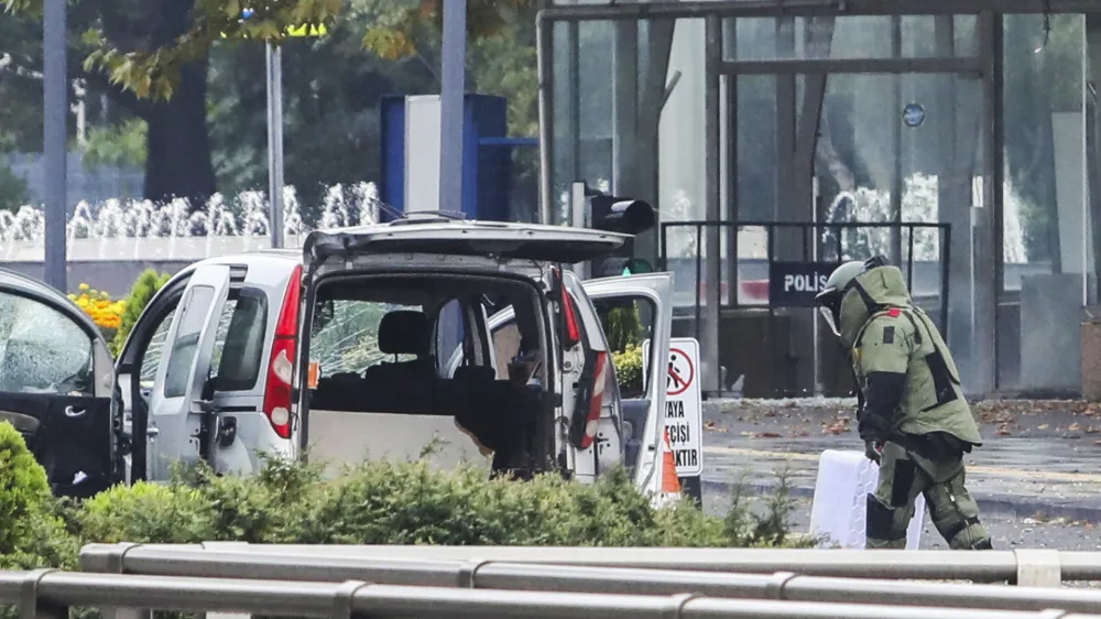 A bomb disposal expert works next to a car after an explosion in Ankara, Sunday, Oct. 1, 2023. A suicide bomber detonated an explosive device in the heart of the Turkish capital, Ankara, on Sunday A second assailant was killed in a shootout with police, the interior minister said. (Yavuz Ozden/Dia Images via AP)