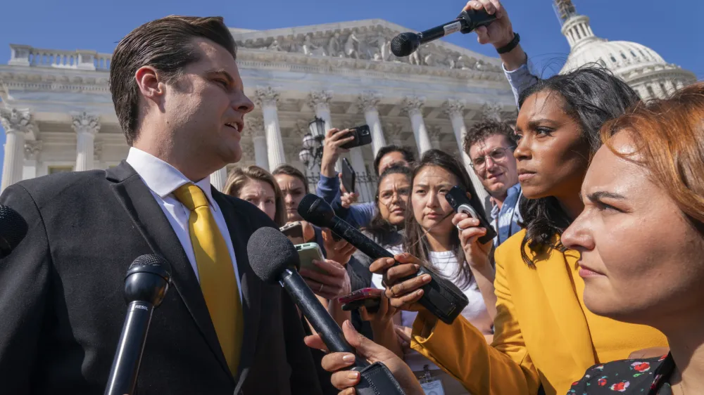 Rep. Matt Gaetz, R-Fla., left, one of House Speaker Kevin McCarthy's harshest critics, answers questions from members of the media after speaking on the House floor, at the Capitol in Washington, Monday, Oct. 2, 2023. Gaetz has said he plans to use a procedural tool called a motion to vacate to try and strip McCarthy of his office as soon as this week. (AP Photo/Jacquelyn Martin)