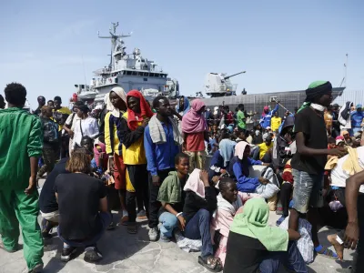 Migrants prepare to board an Italian Navy ship to be taken away from Lampedusa Island after being rescued at sea, Friday, Sept. 15, 2023. Lampedusa, which is closer to Africa than the Italian mainland, has been overwhelmed this week by thousands of people hoping to reach Europe from Tunisia, which has replaced Libya as the main base of operations for migrant smuggling operations in the Mediterranean. (Cecilia Fabiano/LaPresse via AP)