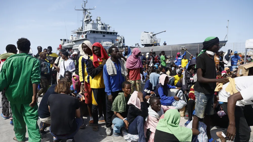 Migrants prepare to board an Italian Navy ship to be taken away from Lampedusa Island after being rescued at sea, Friday, Sept. 15, 2023. Lampedusa, which is closer to Africa than the Italian mainland, has been overwhelmed this week by thousands of people hoping to reach Europe from Tunisia, which has replaced Libya as the main base of operations for migrant smuggling operations in the Mediterranean. (Cecilia Fabiano/LaPresse via AP)