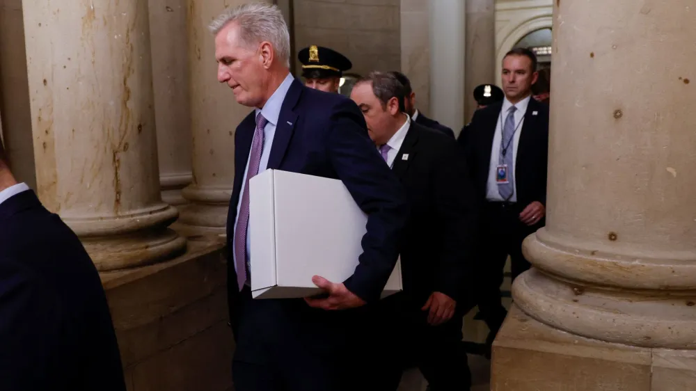 Former Speaker of the House Kevin McCarthy (R-CA) carries a box as he leaves the office of the Speaker of the House and heads out of the U.S. Capitol several hours after being ousted from the position of Speaker by a vote of the House of Representatives on Capitol Hill in Washington, U.S. October 3, 2023. REUTERS/Jonathan Ernst