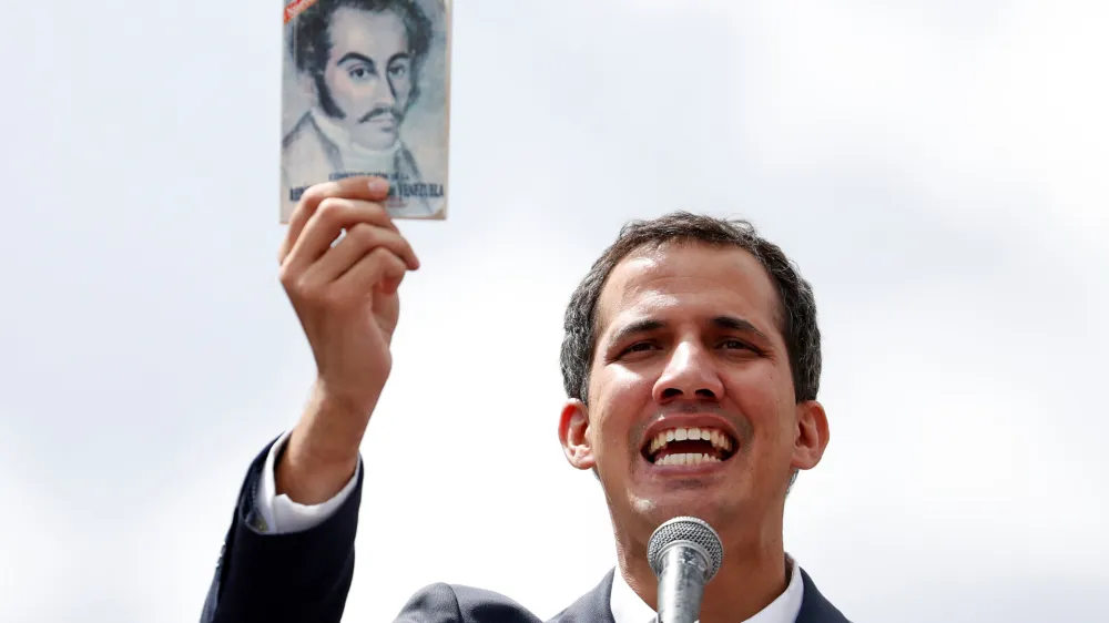 ﻿Juan Guaido, President of Venezuela's National Assembly, holds a copy of Venezuelan constitution during a rally against Venezuelan President Nicolas Maduro's government and to commemorate the 61st anniversary of the end of the dictatorship of Marcos Perez Jimenez in Caracas, Venezuela January 23, 2019. REUTERS/Carlos Garcia Rawlins