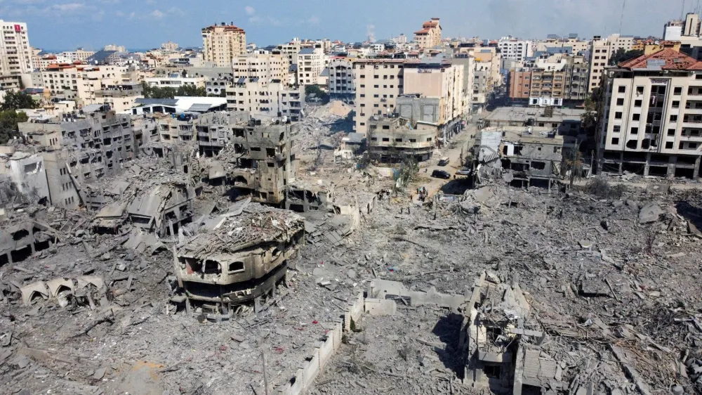 FILE PHOTO: A view shows houses and buildings destroyed by Israeli strikes in Gaza City, October 10, 2023. REUTERS/Mohammed Salem/File Photo