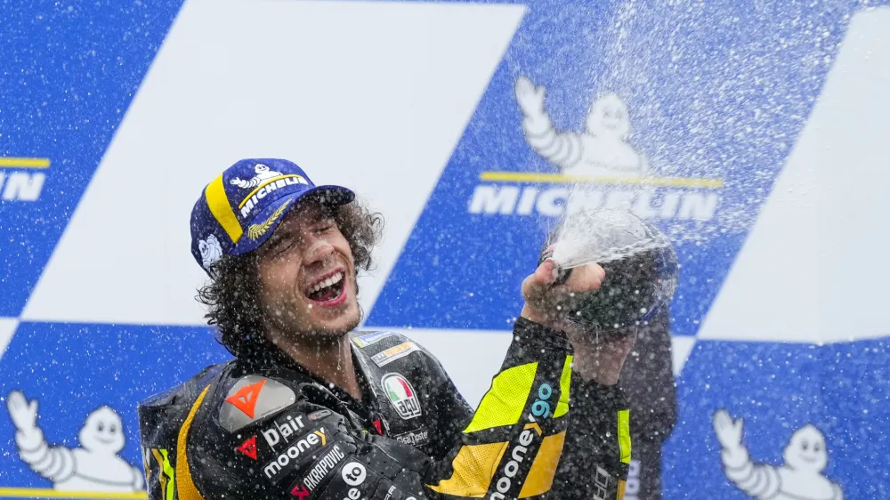 Italy's Marco Bezzecchi, of Ducati Mooney VR46 Racing, celebrates on the podium winning the Moto GP race in Termas de Rio Hondo, Argentina, Sunday, April 2, 2023. (AP Photo/Natacha Pisarenko)