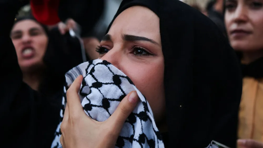 A woman looks on during a protest to express support for Palestinians, in Rome, Italy, October 13, 2023. REUTERS/Yara Nardi