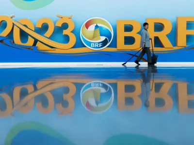 A cleaner walks past signage at China National Convention Center ahead of the Third Belt and Road Forum in Beijing, China October 16, 2023. REUTERS/Edgar Su