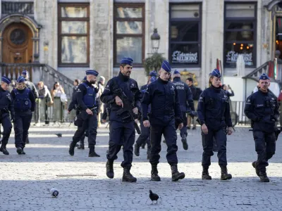 Belgian Police patrol the Grand Place in central Brussels, Tuesday, Oct. 17, 2023, following the shooting of two Swedish soccer fans who were shot by a suspected Tunisian extremist on Monday night. Police in Belgium have shot dead a suspected Tunisian extremist accused of killing two Swedish soccer fans in a brazen attack on a Brussels street before disappearing into the night on Monday. (AP Photo/Martin Meissner)