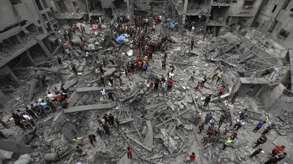 Palestinians inspect the damage of destroyed buildings following Israeli airstrikes on Gaza City, Friday, Oct. 27, 2023. (AP Photo/Abed Khaled)