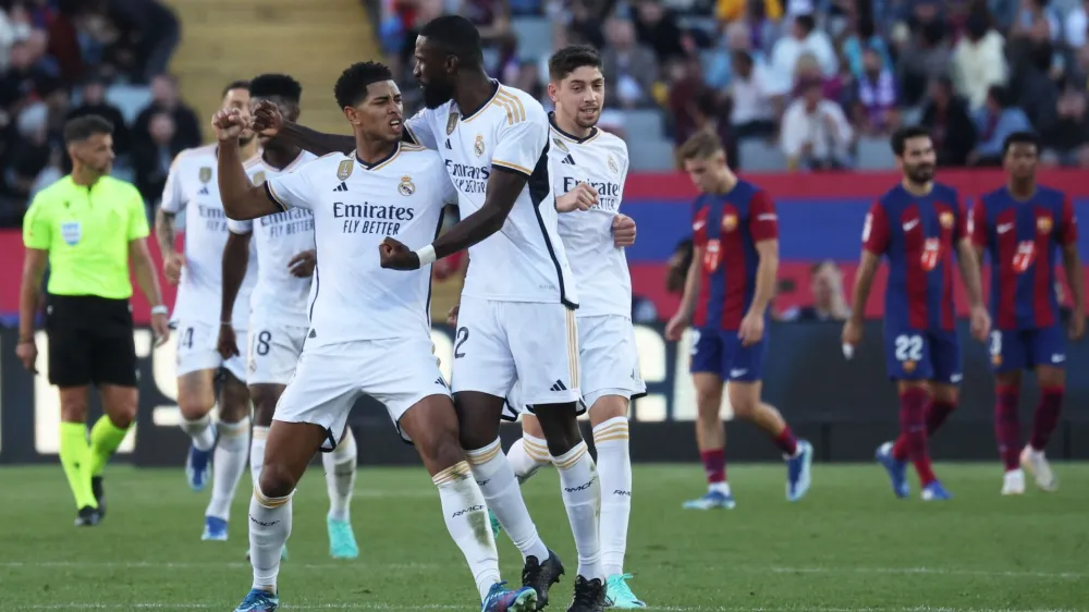 Soccer Football - LaLiga - FC Barcelona v Real Madrid - Estadi Olimpic Lluis Companys, Barcelona, Spain - October 28, 2023 Real Madrid's Jude Bellingham celebrates scoring their first goal with Antonio Rudiger REUTERS/Nacho Doce