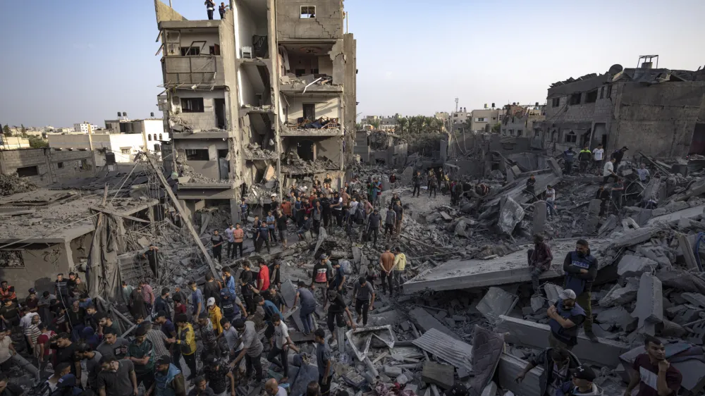 Palestinians look for survivors of the Israeli bombardment in the Maghazi refugee camp in the Gaza Strip, Sunday, Nov. 5, 2023. (AP Photo/Fatima Shbair)