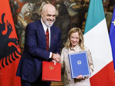 Italy's Premier Giorgia Meloni, right, and Albania's Prime Minister Edi Rama, left, shake hands after the signing of a memorandum of understanding on migrant management centres during a meeting in Rome, Italy, Monday, Nov. 6, 2023. (Roberto Monaldo/LaPresse via AP)