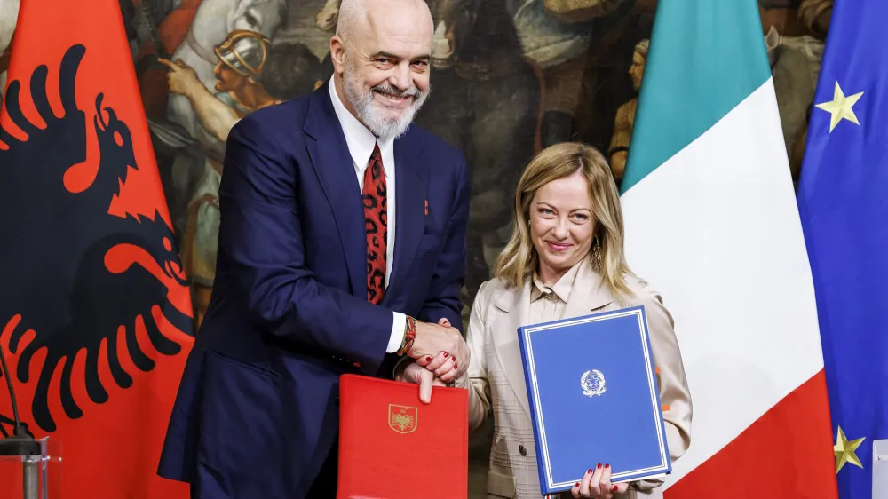 Italy's Premier Giorgia Meloni, right, and Albania's Prime Minister Edi Rama, left, shake hands after the signing of a memorandum of understanding on migrant management centres during a meeting in Rome, Italy, Monday, Nov. 6, 2023. (Roberto Monaldo/LaPresse via AP)