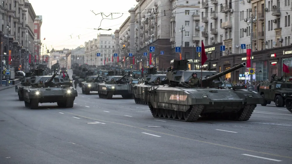 New Russian T-14 Armata tanks, foreground, make their way to Red Square during a rehearsal for the Victory Day military parade which will take place at Moscow's Red Square on May 9 to celebrate 70 years after the victory in WWII, in Moscow, Russia, Monday, May 4, 2015. Russia's new Armata tank has appeared in public for the first time, rumbling down a broad Moscow avenue on its way to Red Square for the Victory Day parade's final rehearsal. (AP Photo/Alexander Zemlianichenko)