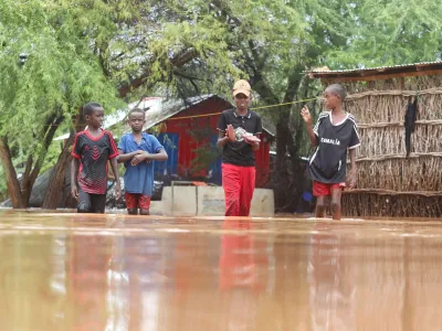 Somali children wade through flood water following heavy rains that have led the Juba river to overflow and flood large swathes of land in Dolow, Gedo region, Jubaland State of Somalia, November 12, 2023. REUTERS/Feisal Omar