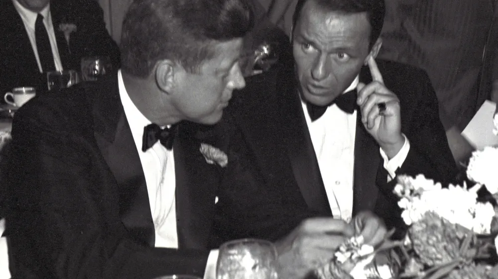 US Senator (and future US President) John F Kennedy (1917 - 1963) (left) and entertainer Frank Sinatra (1915 - 1998) attend a black tie, Democratic Committee Dinner at the Beverly Hilton Hotel, Los Angeles, California, July 10, 1960. (Photo by Benjamin E. 'Gene' Forte/CNP/Getty Images)