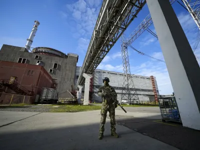 FILE - A Russian serviceman guards an area of the Zaporizhzhia Nuclear Power Station in territory under Russian military control, southeastern Ukraine, on May 1, 2022. Ukraine and Russia accused each other Wednesday, July 5, 2023, of planning to attack the power plant, which is occupied by Russian troops, but neither side provided evidence to support their claims. (AP Photo, File)