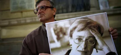 A protester holds a picture of murdered Russian journalist Anna Politkovskaya during a demonstration for freedom of speech and the press in Sofia October 7, 2008. Politkovskaya, a critic of the former Russian President Putin, was shot dead in her Moscow apartment building two years ago. REUTERS/Stoyan Nenov  (BULGARIA)