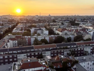 FILE - In this Sept. 7, 2021 file photo the sun goes down behind apartment houses in Berlin, Germany. Berlin's city government said Friday it is buying some 14,750 apartments from two large corporate landlords for 2.46 billion euros (.9 billion) — a deal announced a week before local and national elections as the German capital tries to expand the supply of publicly owned accommodation. (AP Photo/Michael Sohn, File)