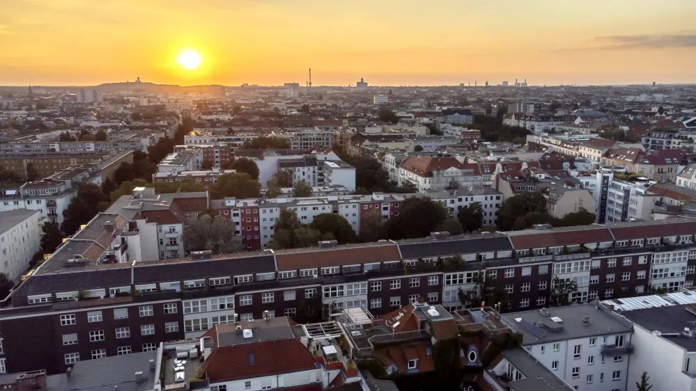 FILE - In this Sept. 7, 2021 file photo the sun goes down behind apartment houses in Berlin, Germany. Berlin's city government said Friday it is buying some 14,750 apartments from two large corporate landlords for 2.46 billion euros ($2.9 billion) — a deal announced a week before local and national elections as the German capital tries to expand the supply of publicly owned accommodation. (AP Photo/Michael Sohn, File)