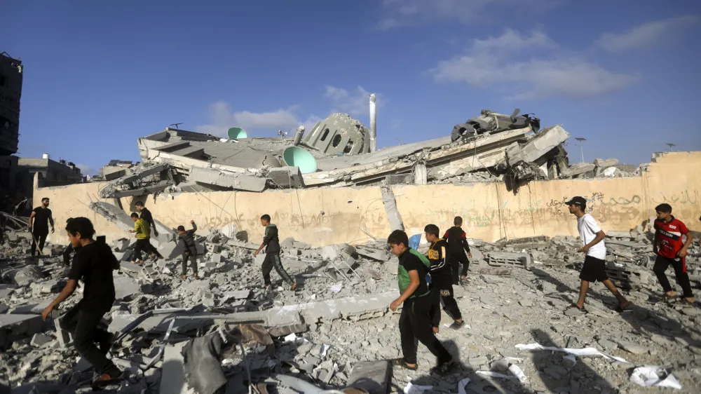 FILE - Palestinians inspect the damage of a destroyed mosque following an Israeli airstrike in Khan Younis refugee camp, southern Gaza Strip on Nov. 8, 2023. Entire generations of Palestinian families in the besieged Gaza Strip have been killed in airstrikes in the ongoing Hamas-Israel war. They include infants to elderly grandparents, killed in attacks the Israeli army says aim to root out the militant group from the densely populated coastal territory. (AP Photo/Mohammed Dahman, File)