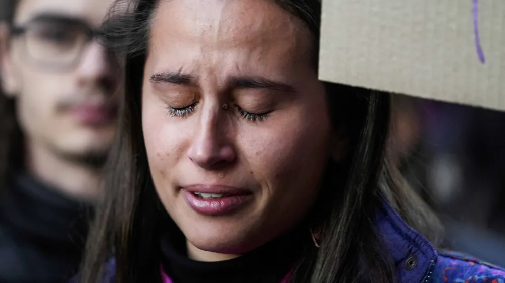 A student cries as she participates in a flash mob 'A minute of noise for Giulia' outside the Statale University, in Milan, Italy, Wednesday, Nov. 22, 2023. Italy has erupted in outrage over the death of a young woman, allegedly at the hands of her possessive ex-boyfriend. It's the latest in a series of cases of gender-based violence that has claimed the lives of more than 50 women so far this year in Italy. (AP Photo/Luca Bruno)