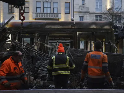 A burned out Luas is removed from O'Connell Street in the aftermath of violent scenes in the city centre on Thursday evening, in Dublin, early Friday, Nov. 24, 2023. The unrest came after an attack on Parnell Square East where five people were injured, including three young children. (Brian Lawless/PA via AP)